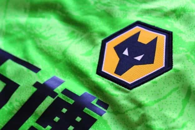 A green football shirt with a Wolverhampton Wanderers logo on it.