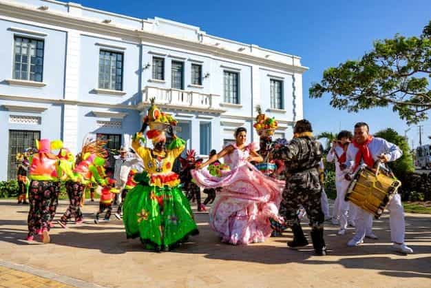 People in colorful dress dance during a celebration in Colombia.