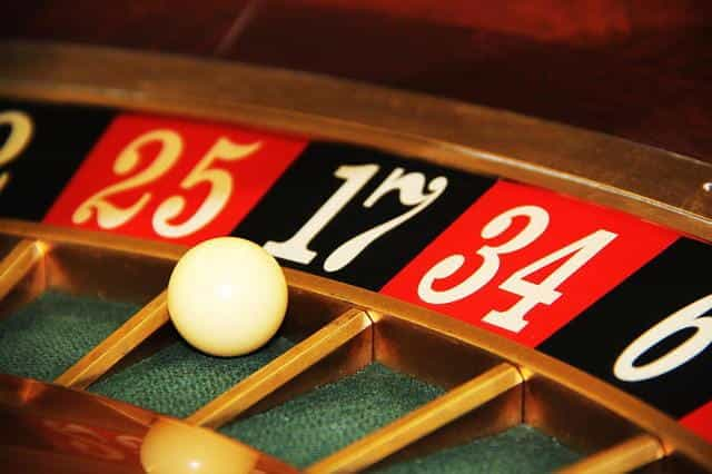 A classic game of roulette at a casino, with the ball spinning around the roulette wheel.