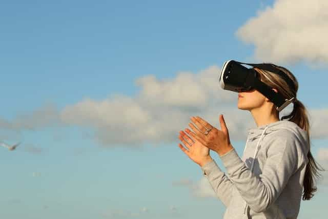 A woman wearing a Virtual Reality headset.