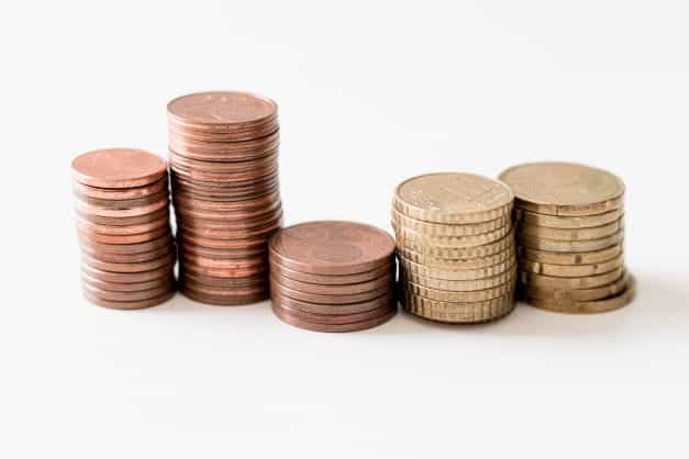 Stacks of different colored coins lined up next to each other.