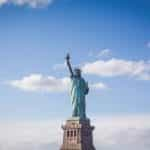 The Statue of Liberty against a blue sky backdrop.