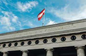 Austrian flag flying over the Hofburg Palace in Vienna.