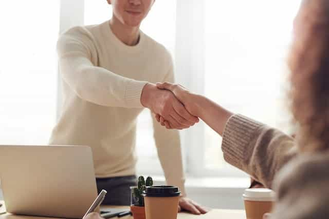 Two colleagues shake hands.