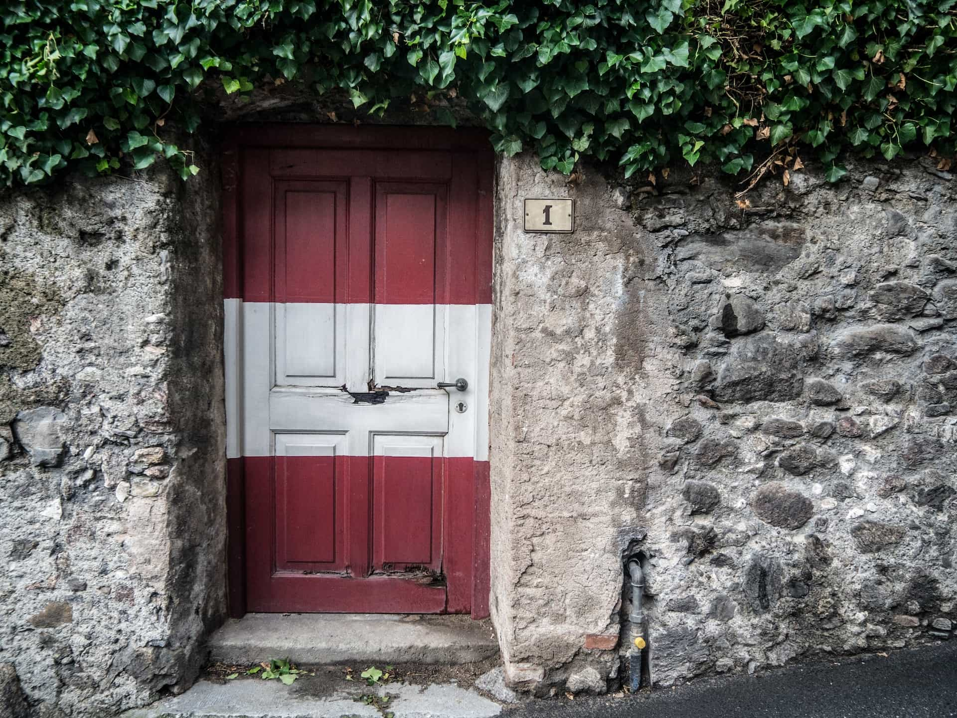 A door painted in the colors of the Austrian flag.