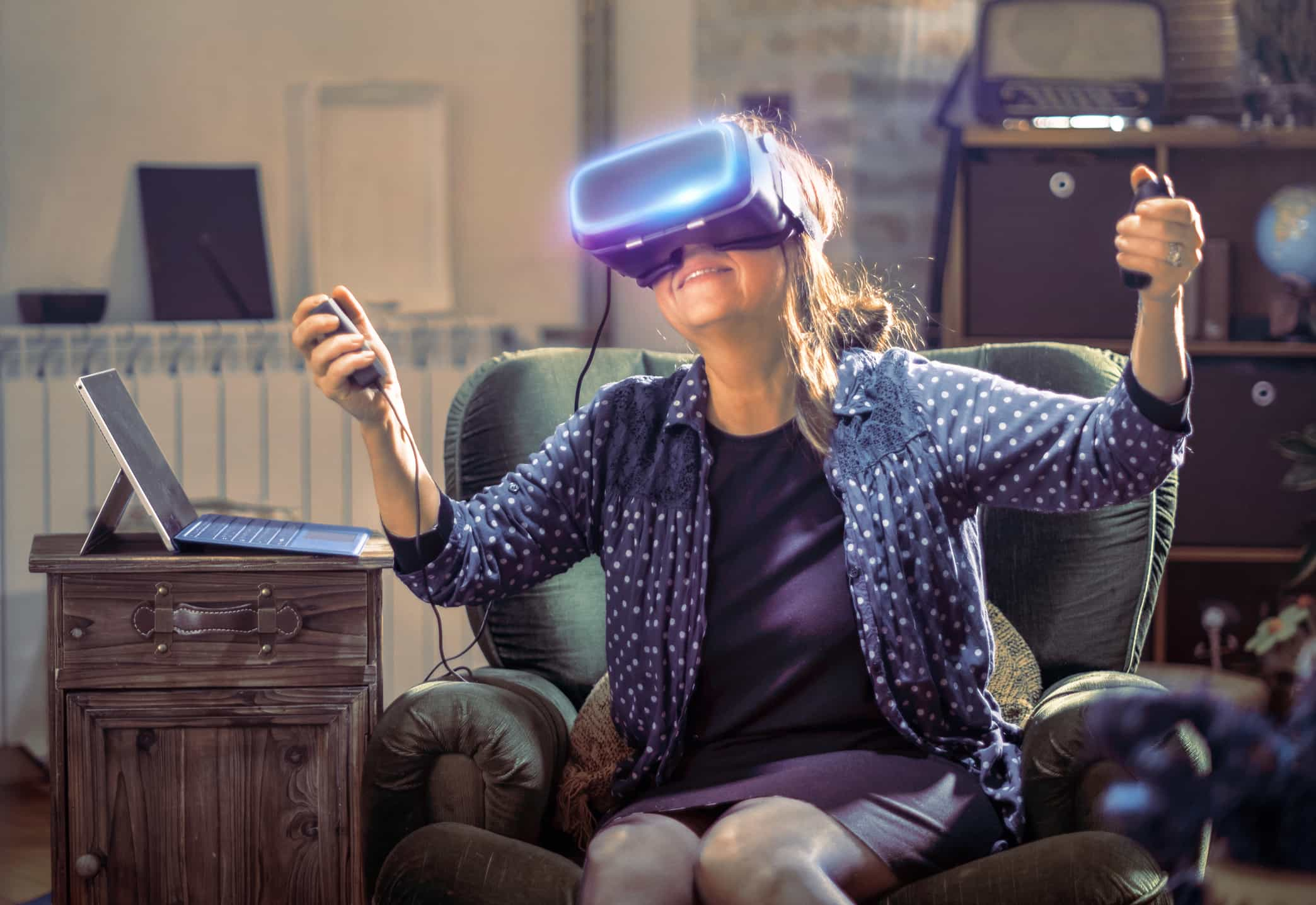 A smiling woman trying a virtual reality headset.