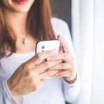 A Woman Playing Casino Games on Her Mobile Phone